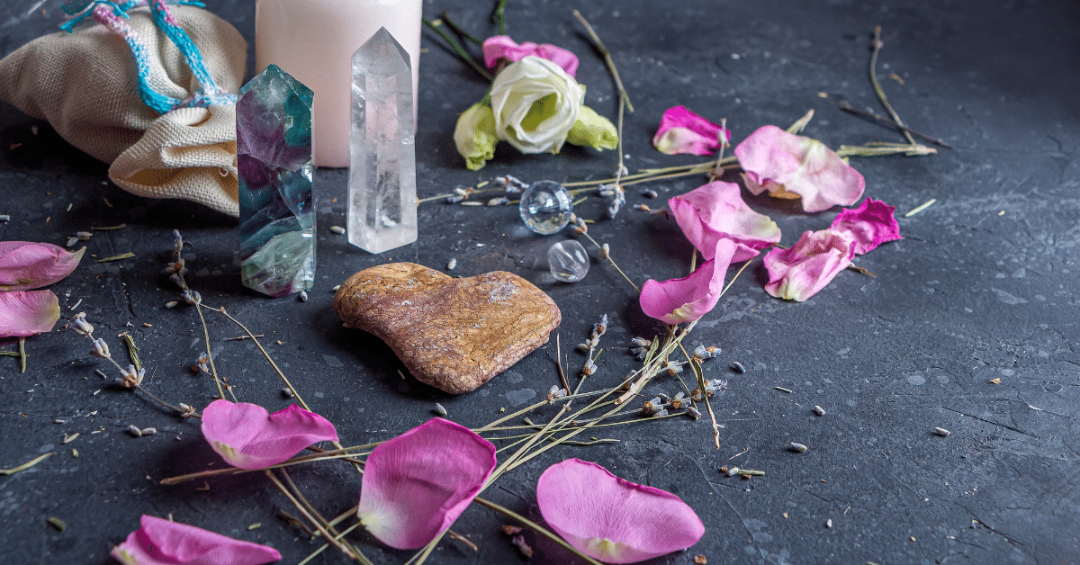 A heart-shaped stone surrounded by romantic items